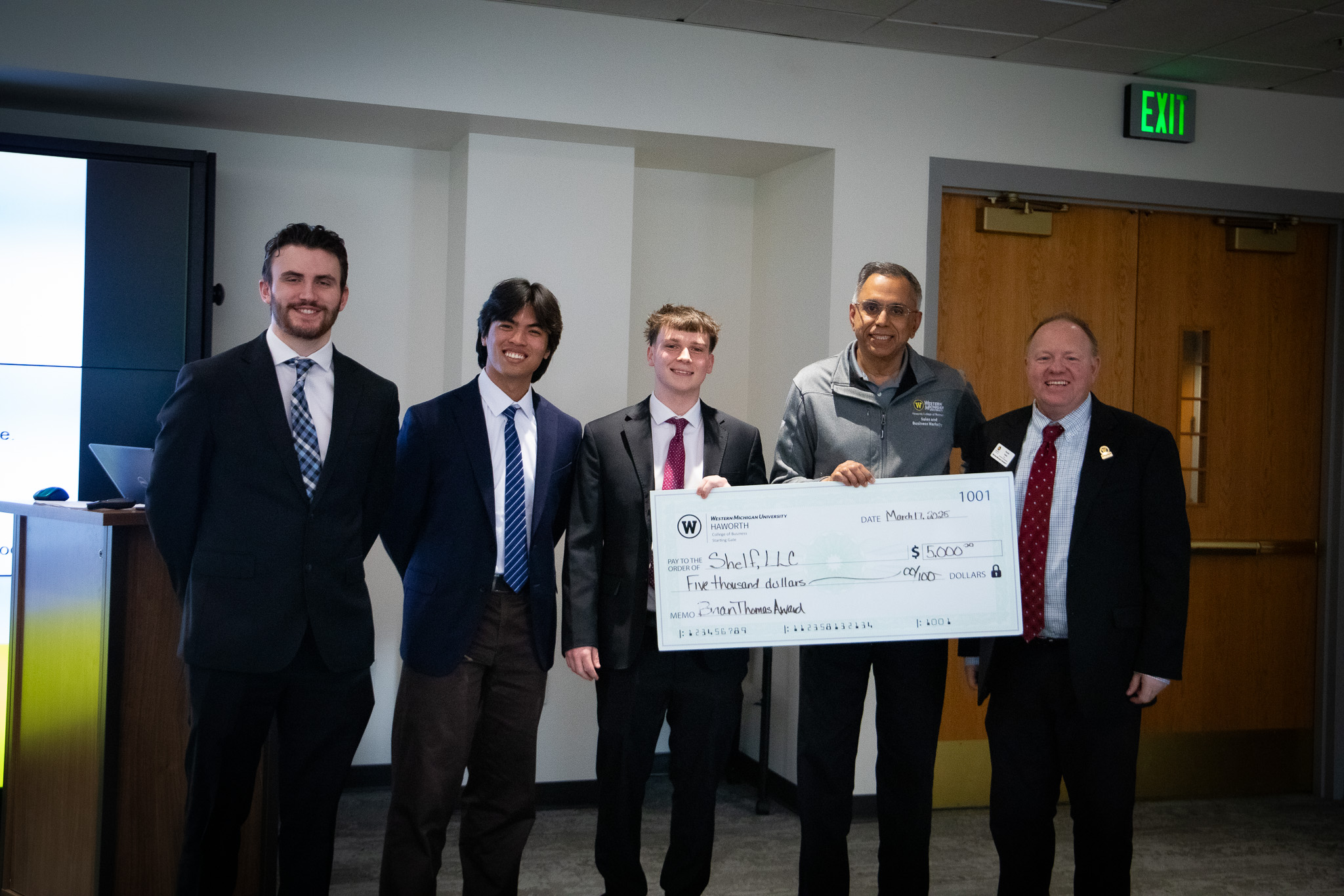Shelf team receiving an investment check from WMU with the Haworth College of Business Dean and Head Chair